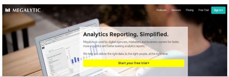A webpage for Megalytic features a banner image with a laptop displaying analytics graphs. The text overlay reads, "Analytics Reporting, Simplified." Used by digital agencies, marketers, SEO experts, and business owners for faster, more insightful and visually appealing reports. A yellow button says, "Start your free trial." The navigation bar includes "Features," "Services," "Pricing," "Free Trial,