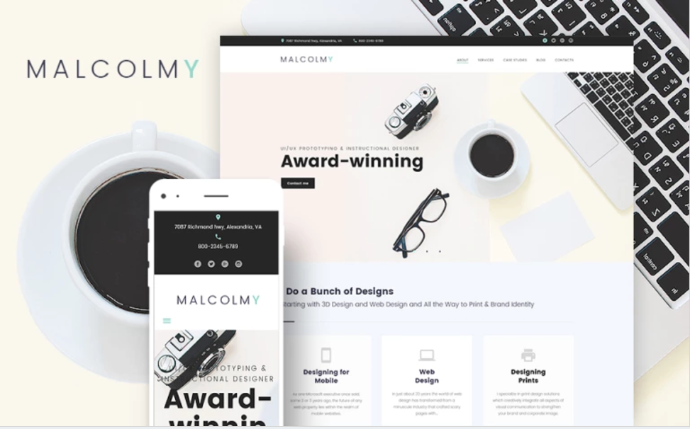 A website mockup displaying a minimalistic design for "Malcolmy," featuring a clean white background, a headline noting "Award-winning" designs, and images of a camera and glasses. A smartphone on the left shows a mobile version of the same WordPress site. A coffee cup and laptop are in the background.
