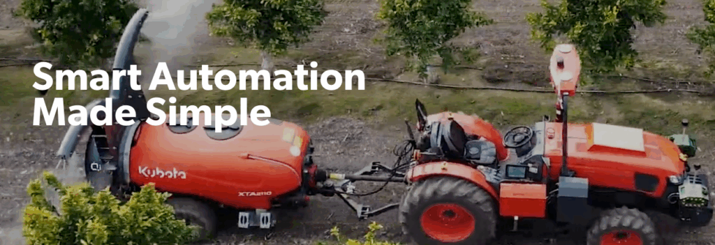 A red Kubota tractor with an attached sprayer drives through an orchard. White bold text reads “Smart Automation Made Simple.” Trees and rows of crops highlight how practical solutions drive key investments in modern farming.
